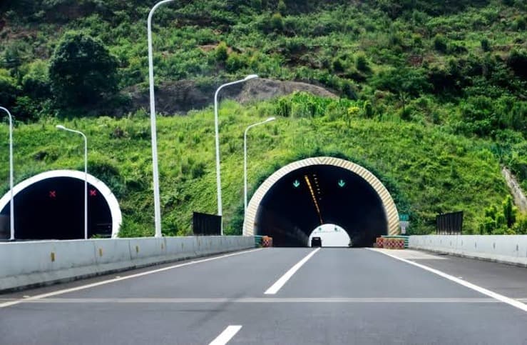 A road seen from inside a concrete tunnel